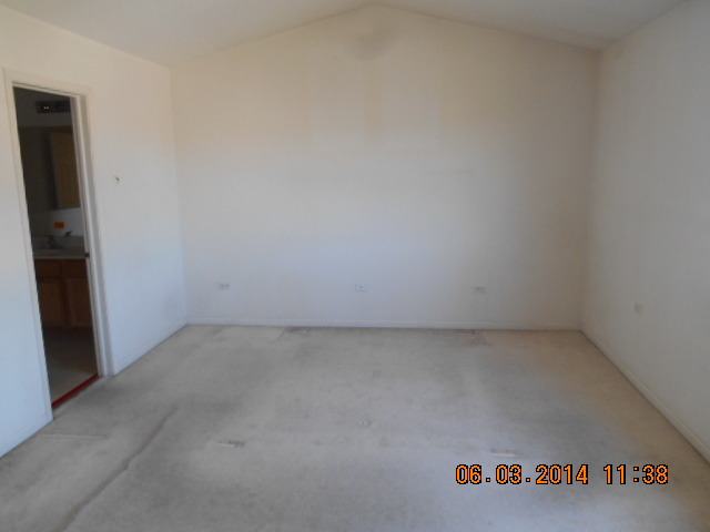 132 Enclave Circle, Unit D Bolingbrook, IL 60440 - Photo 8 of 9 an empty room with a bench