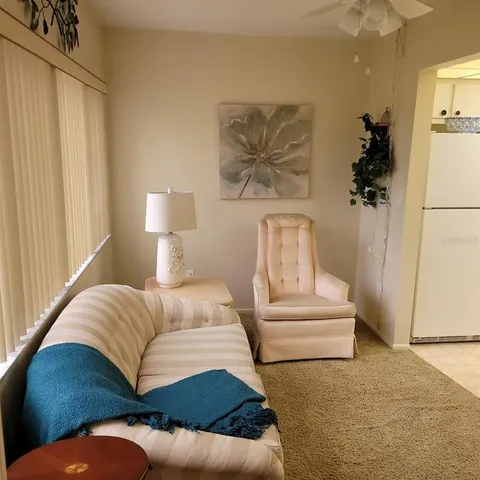 a view of a swimming pool with a couch and windows