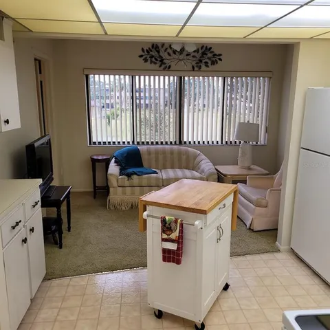 a view of an entryway with wooden cabinets