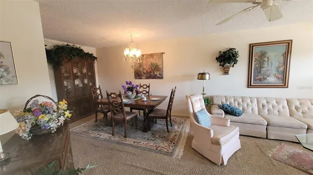 a dining room with furniture and a chandelier
