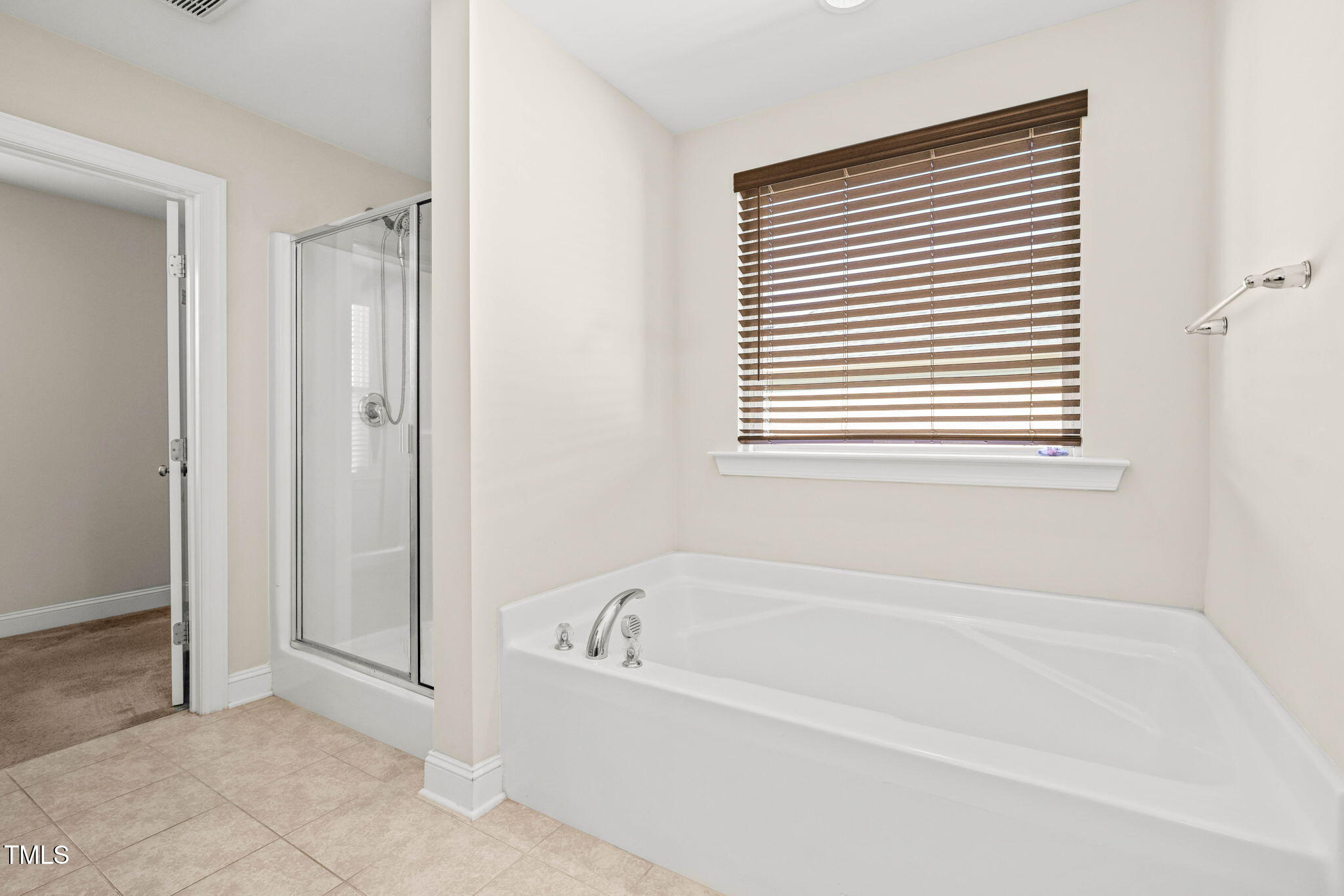 4508 Brintons Cottage Street Raleigh, NC 27616 - Photo 25 of 46 a white bath tub sitting next to a window