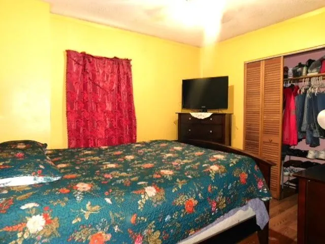 a bedroom with a bed and a flat screen tv