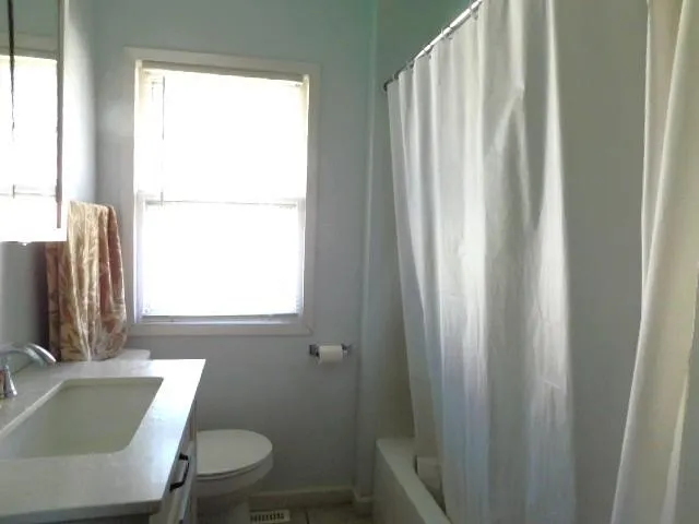 a bathroom with a sink a toilet and tub