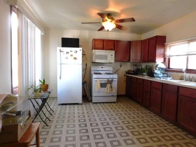 a kitchen with stainless steel appliances a stove a sink a microwave and cabinets