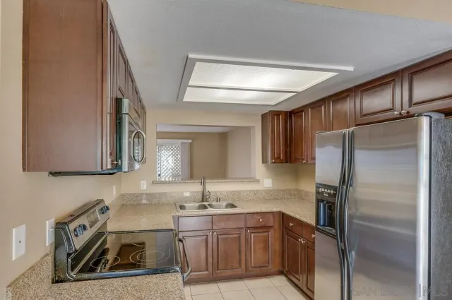 a kitchen with stainless steel appliances a refrigerator and a stove