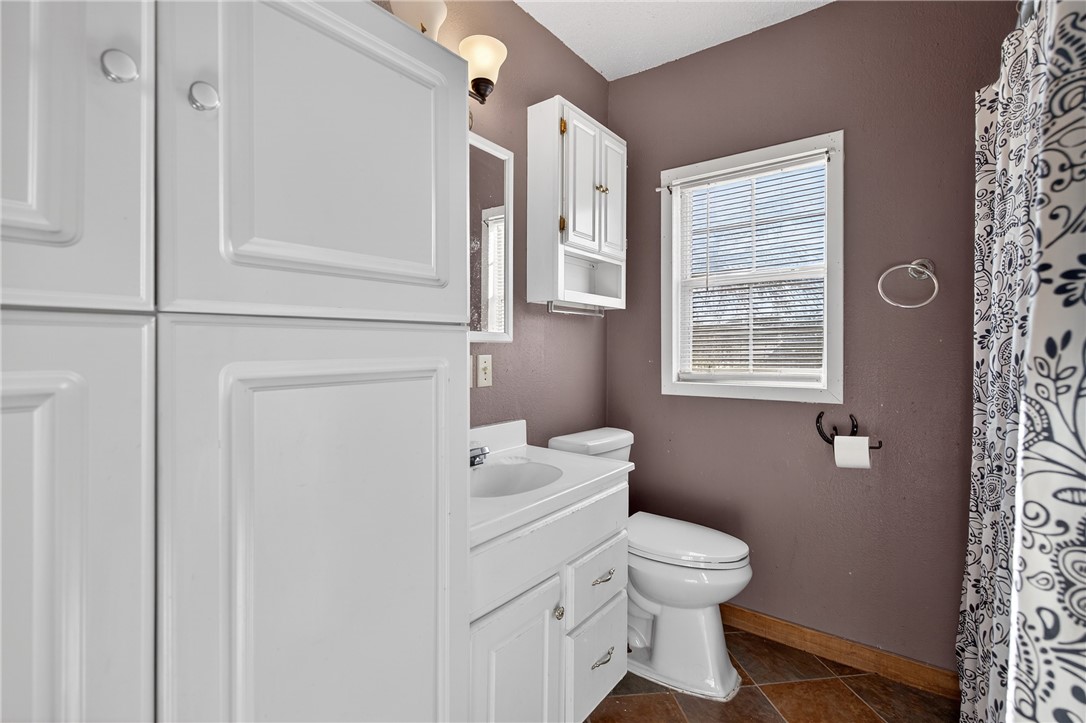 5752 Mockingbird Lane Mathis, TX 78368 - Photo 18 of 35 a bathroom with a toilet a sink and a window
