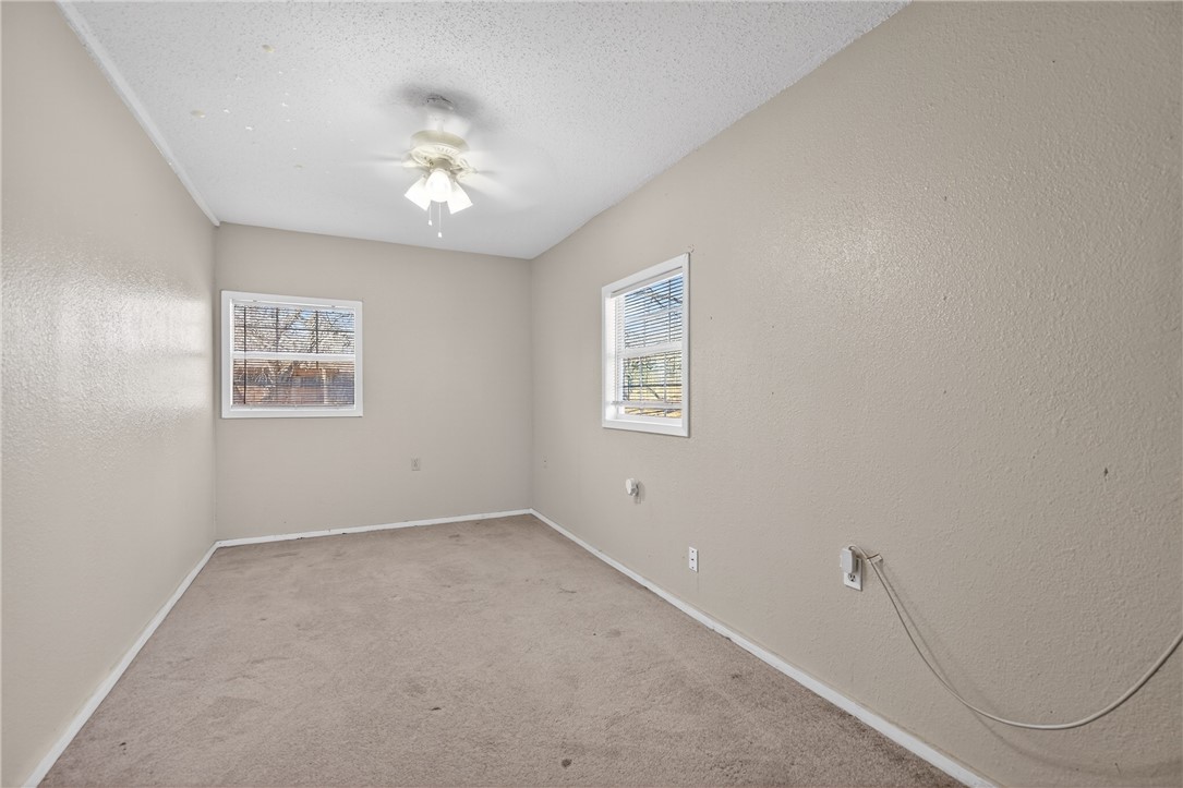 5752 Mockingbird Lane Mathis, TX 78368 - Photo 21 of 35 wooden floor in an empty room with a window