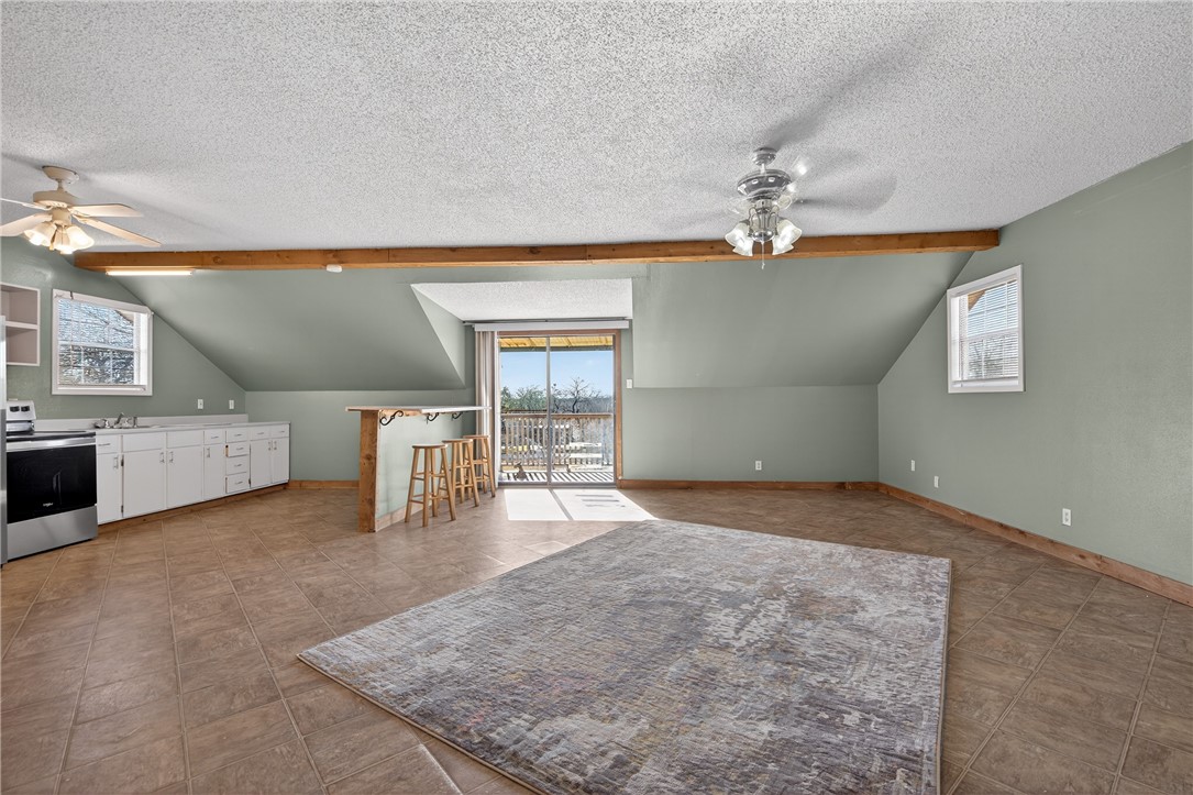 5752 Mockingbird Lane Mathis, TX 78368 - Photo 26 of 35 an empty room with chandelier fan and windows