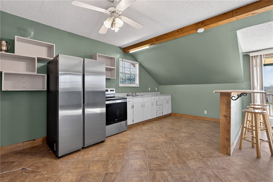 5752 Mockingbird Lane Mathis, TX 78368 - Photo 27 of 35 a kitchen with stainless steel appliances a refrigerator sink and cabinets