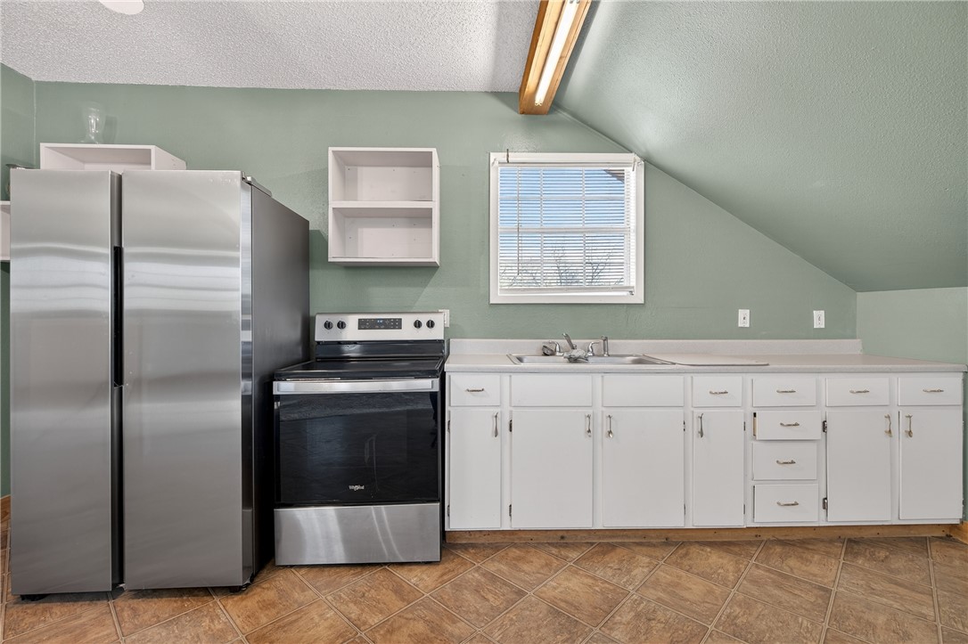5752 Mockingbird Lane Mathis, TX 78368 - Photo 28 of 35 a kitchen with stainless steel appliances a stove a sink and a refrigerator