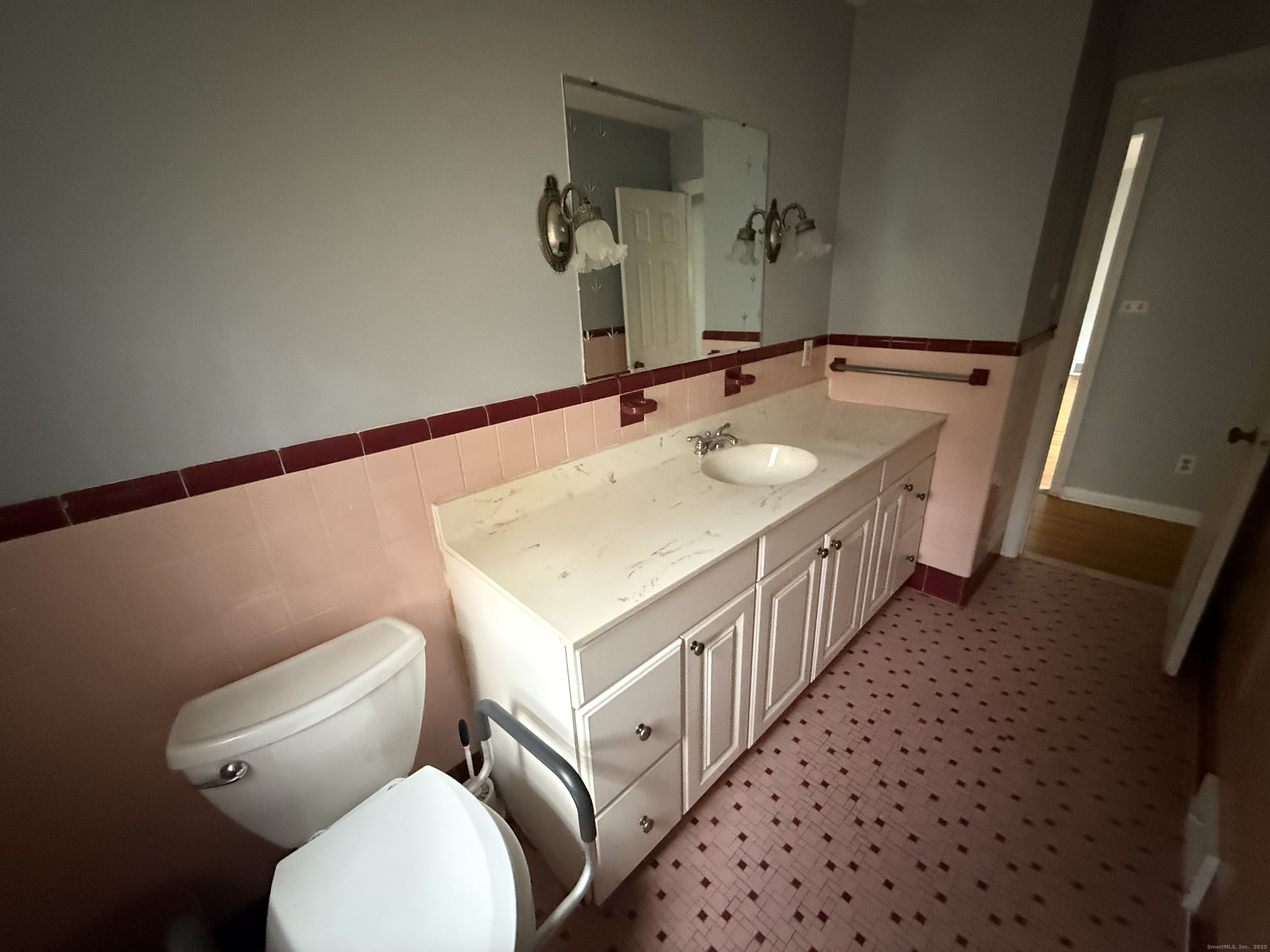 8 Nelson Place Fairfield, CT 06825 - Photo 13 of 32 a bathroom with a sink a toilet and mirror
