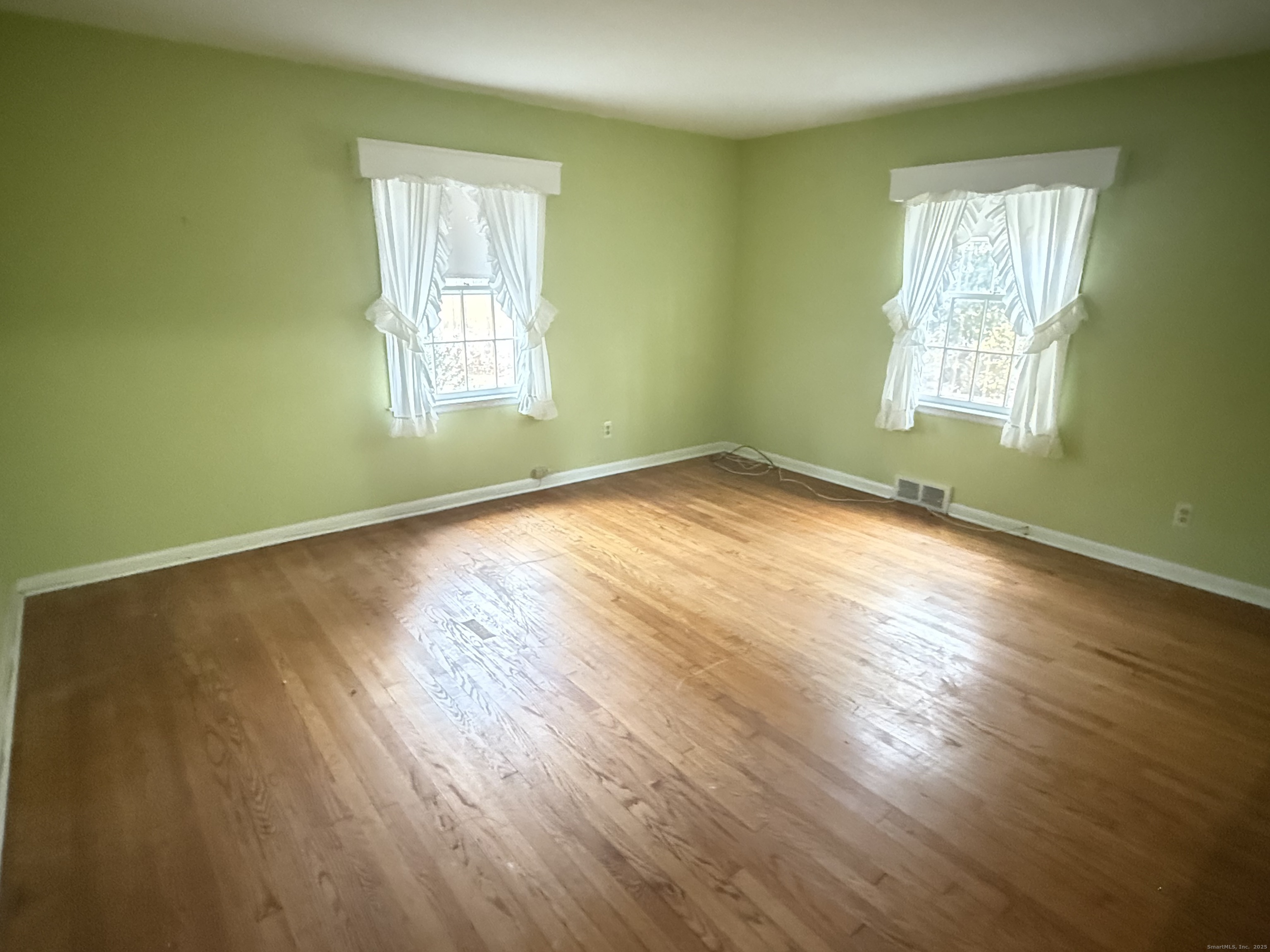 8 Nelson Place Fairfield, CT 06825 - Photo 16 of 32 a view of empty room with wooden floor and fan