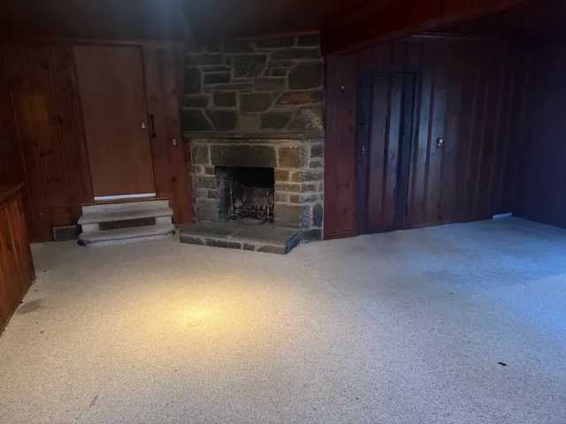 a view of empty room with fireplace