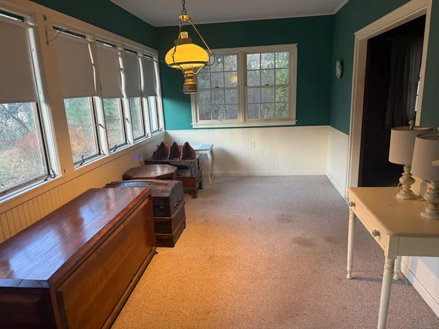 a bedroom with furniture and a large window