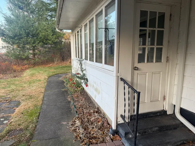 a view of a house with backyard and porch