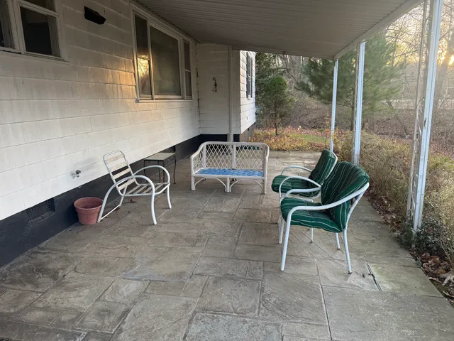 a building outdoor space with patio furniture and potted plants