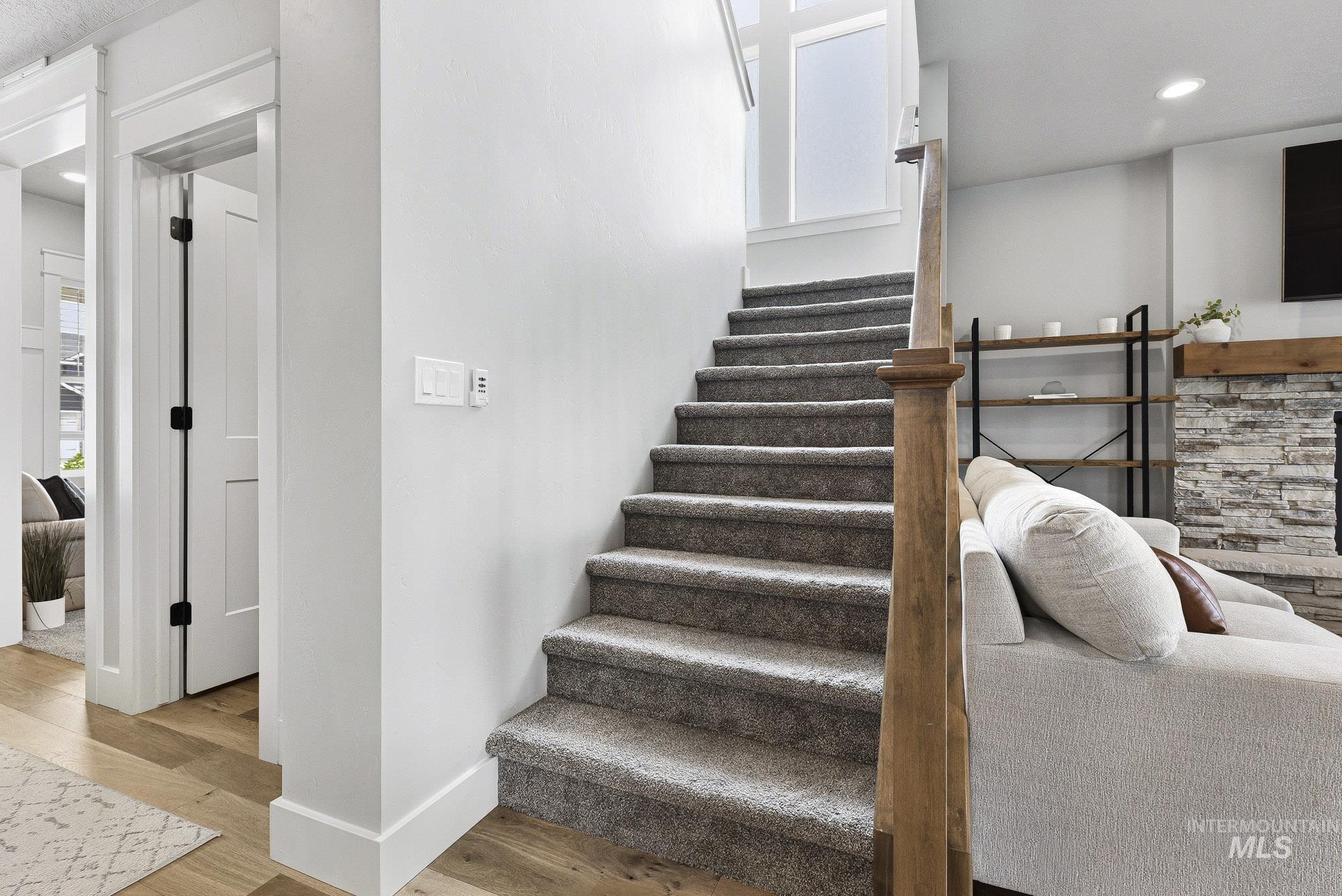 5676 East Zaffre Ridge Street Boise, ID 83716 - Photo 32 of 50 Carpeted staircase with a wood handrail and square newel post