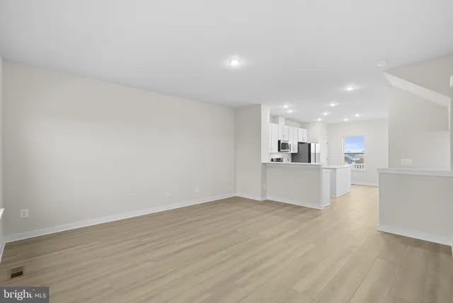 a view of kitchen with kitchen island and wooden floor