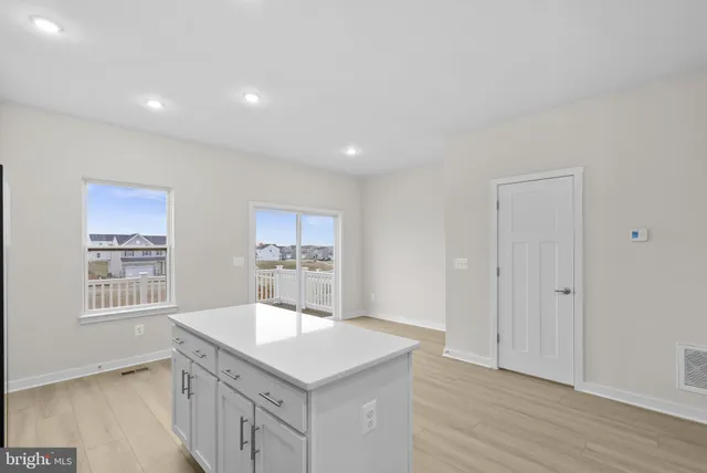 a kitchen with a sink cabinets and wooden floor