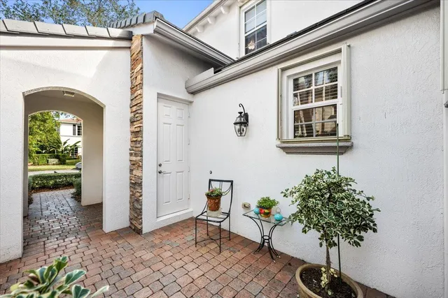 an aerial view of residential houses with outdoor space and ocean view