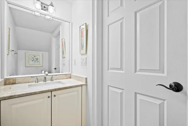 a living room with furniture a flat screen tv and kitchen view