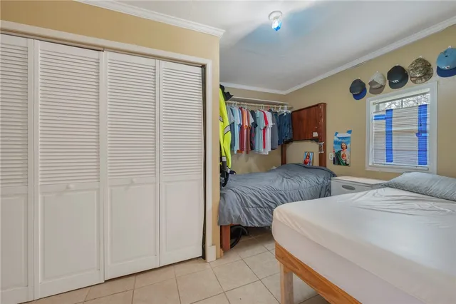 a bedroom with furniture and a book shelf