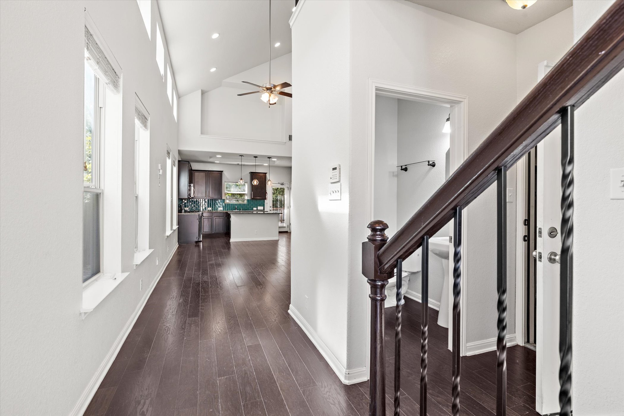 7337 Menchaca Road, Unit #22 Austin, TX 78745 - Photo 4 of 25 Entryway to home, with high vaulted ceiling, wood flooring, ceiling fan, recessed lighting, and stairway