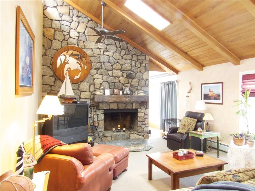 31 Tunxis Road Wolcott, CT 06716 - Photo 1 of 1 a living room with furniture a fireplace and a table