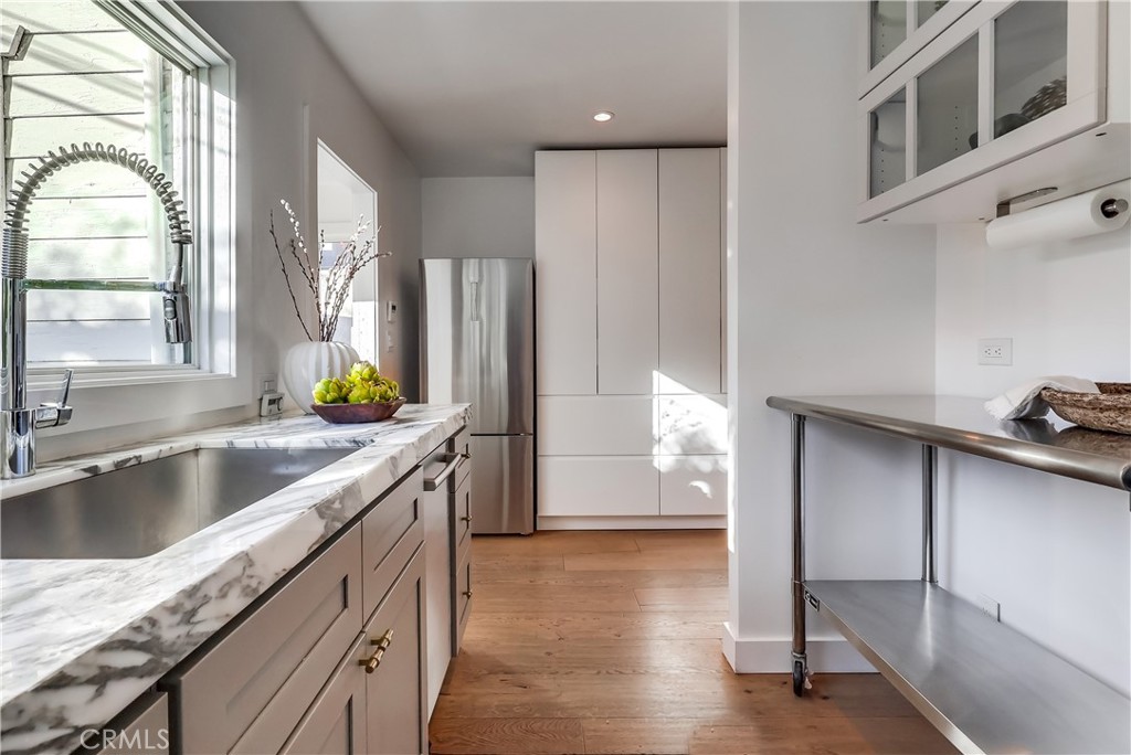1007 Marview Avenue Los Angeles, CA 90012 - Photo 11 of 27 a kitchen with granite countertop a sink a counter top space and cabinets