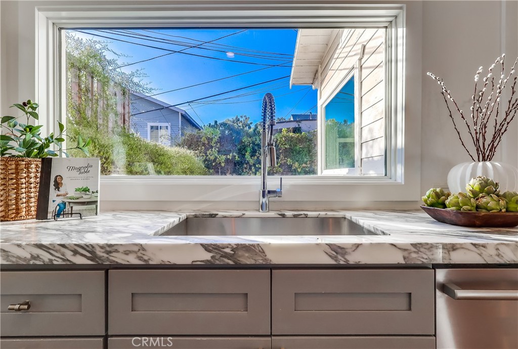 1007 Marview Avenue Los Angeles, CA 90012 - Photo 2 of 27 a kitchen with granite countertop a sink and a white wooden cabinets