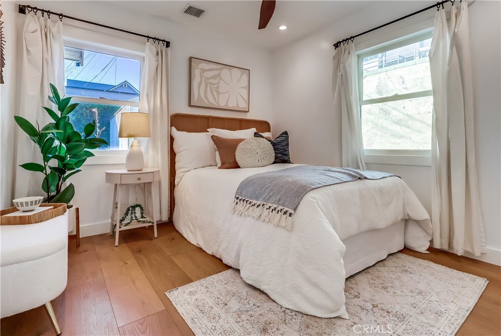 1007 Marview Avenue Los Angeles, CA 90012 - Photo 4 of 27 a large white bed sitting in a bedroom next to a window