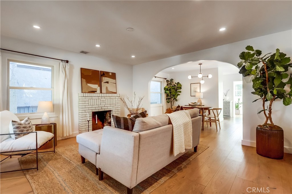 1007 Marview Avenue Los Angeles, CA 90012 - Photo 6 of 27 a living room with furniture a fireplace and a potted plant