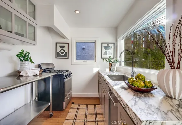 a kitchen with stainless steel appliances granite countertop a sink and cabinets