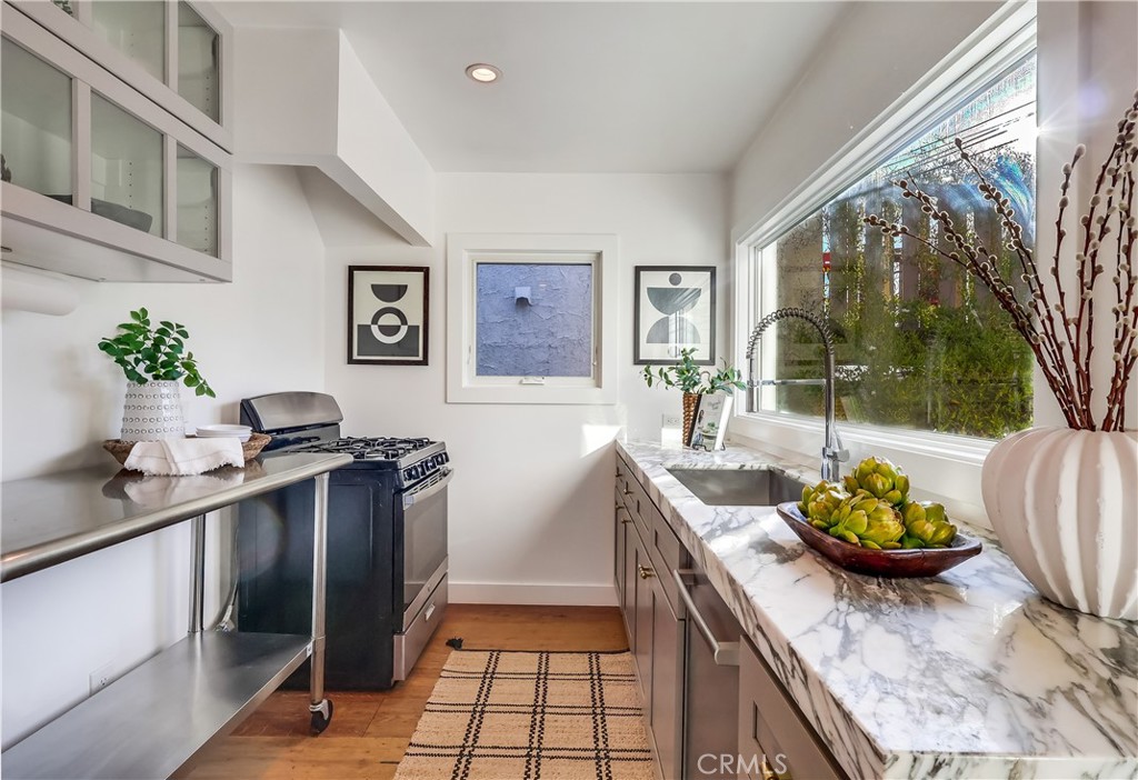 1007 Marview Avenue Los Angeles, CA 90012 - Photo 10 of 27 a kitchen with stainless steel appliances granite countertop a sink and cabinets