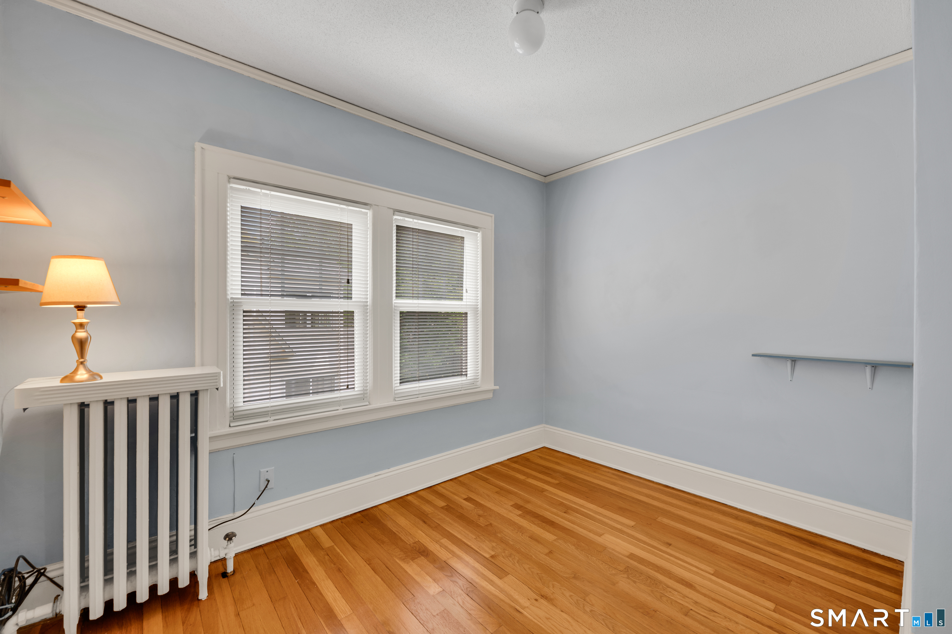 44 Beverly Road Wethersfield, CT 06109 - Photo 16 of 31 an empty room with wooden floor and windows