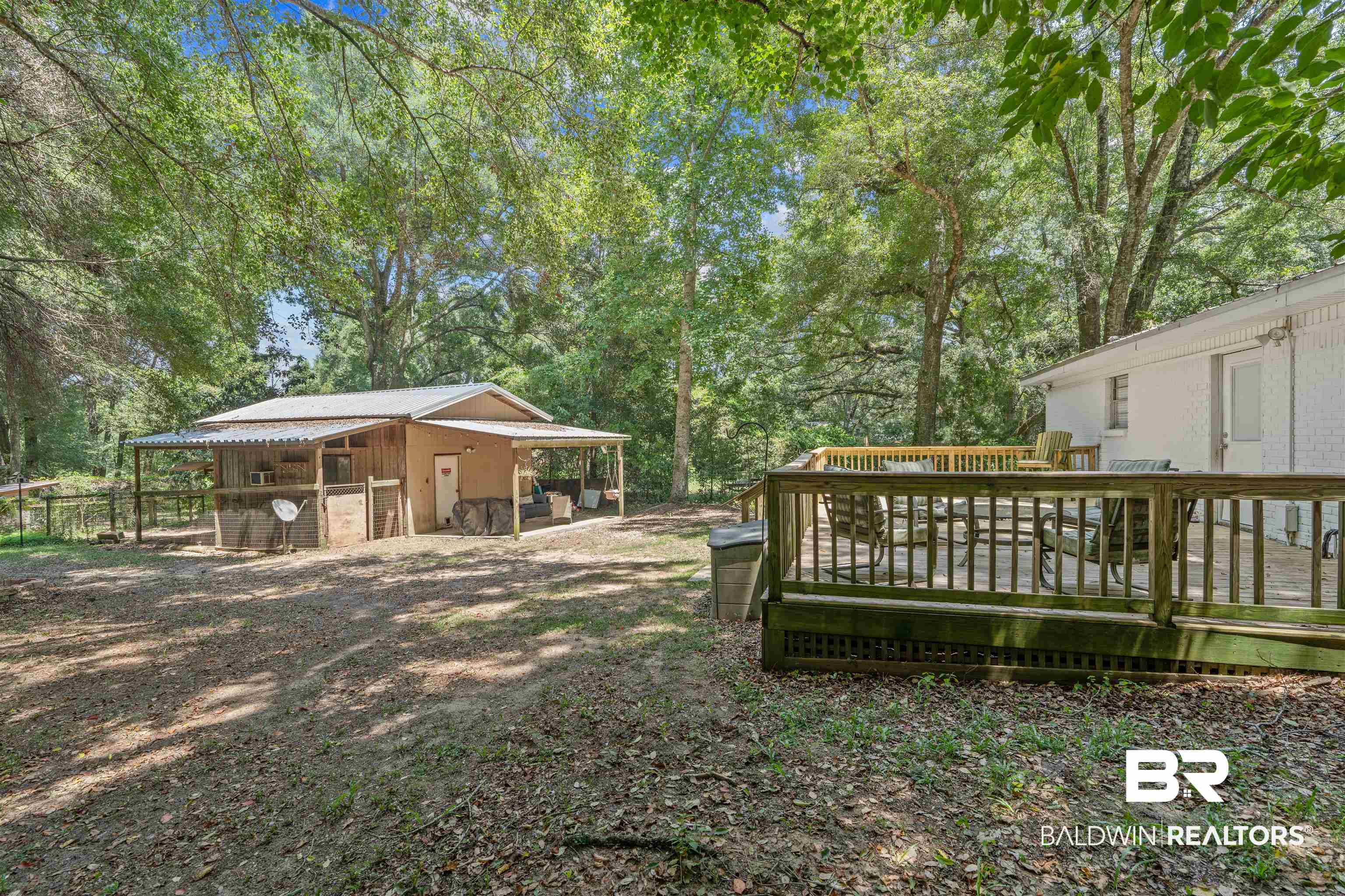 922 Dauphine Circle Daphne, AL 36526 - Photo 24 of 29 View of yard with an outdoor structure, view of wooded area, and a deck