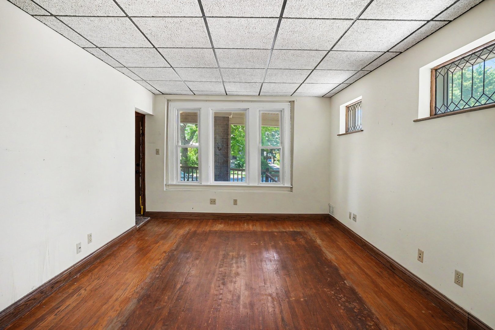 1661 Burr Oak Road Homewood, IL 60430 - Photo 5 of 17 a view of an empty room with wooden floor and a window