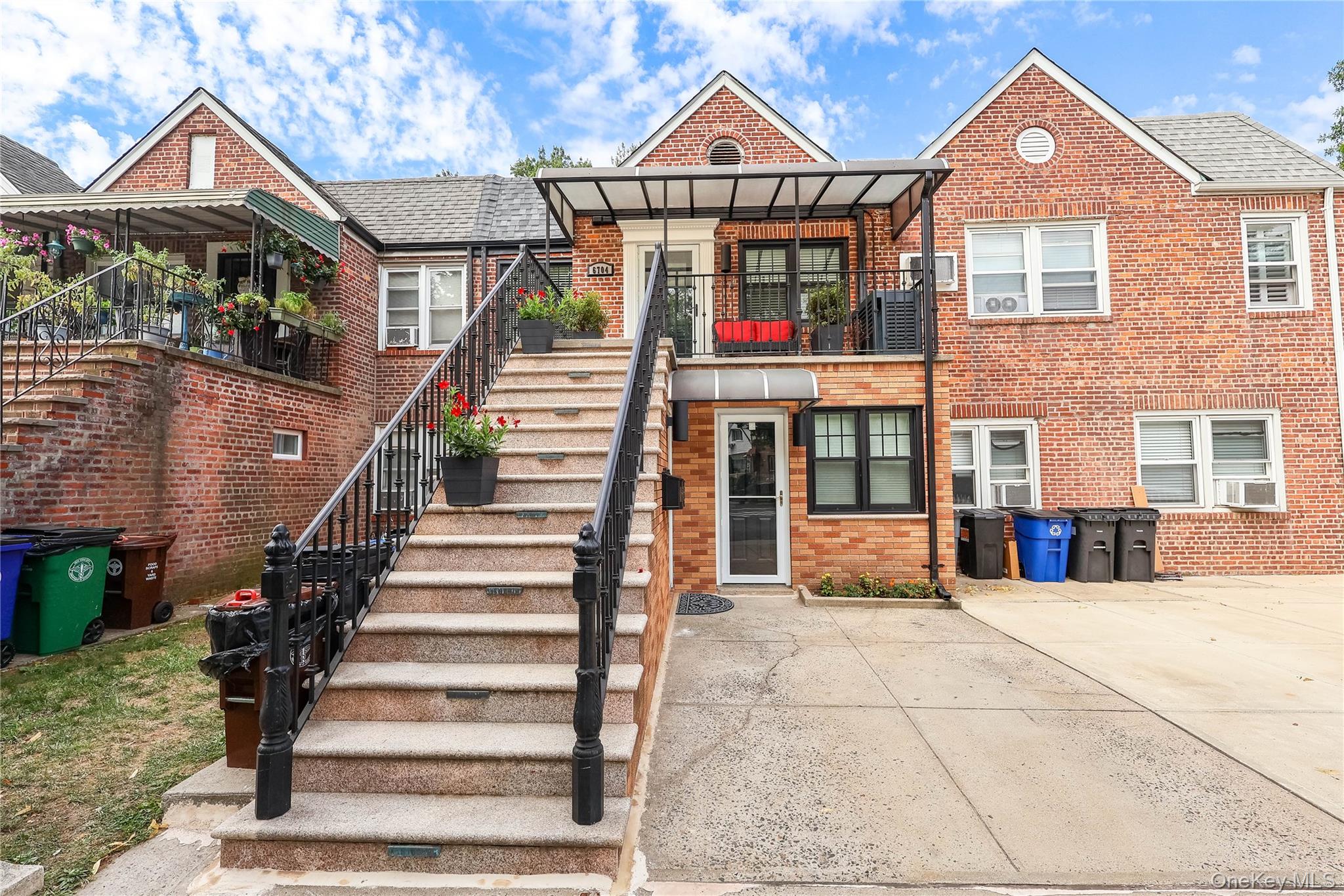 67-04 Selfridge Street, Unit 2 Queens, NY 11375 - Photo 1 of 21 a front view of a house with a yard and a garage