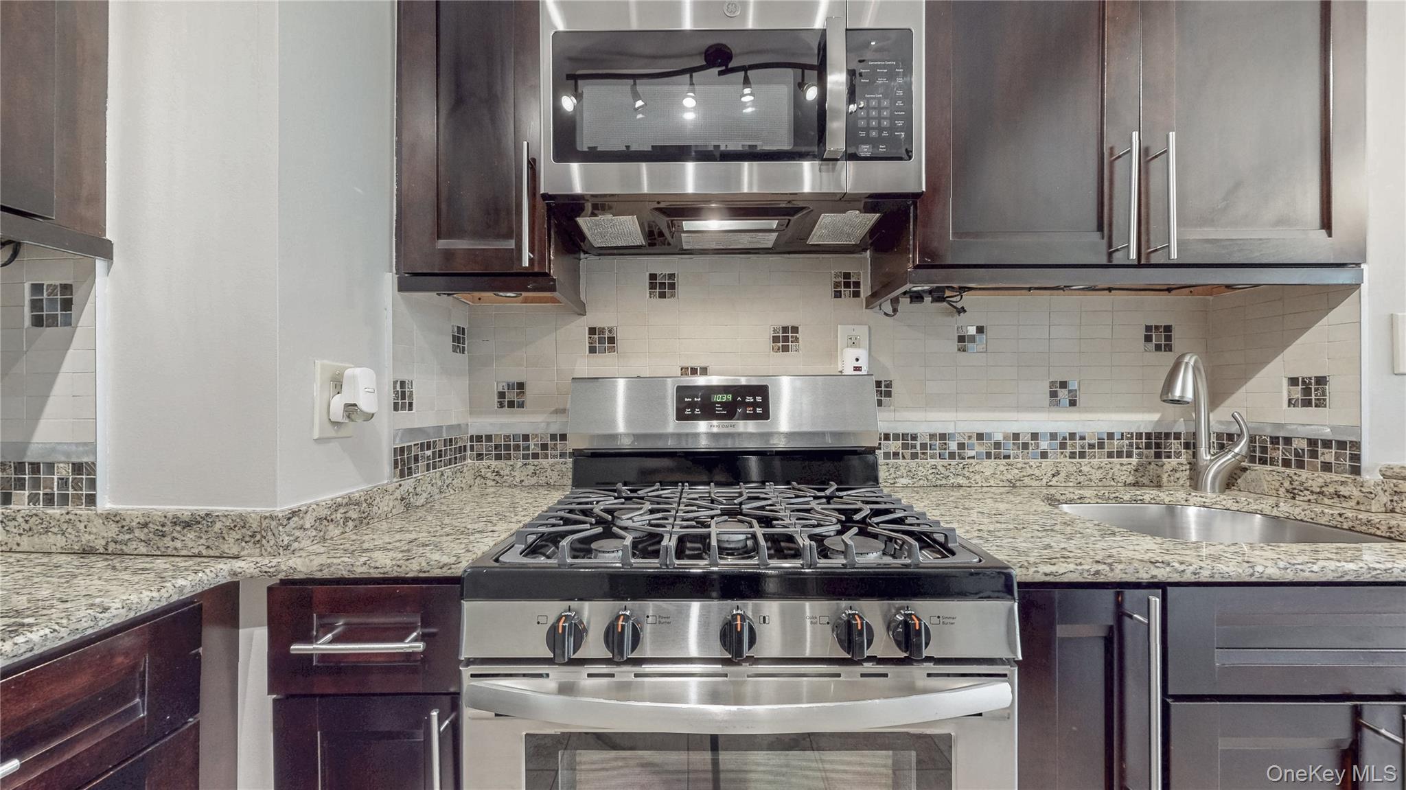 67-04 Selfridge Street, Unit 2 Queens, NY 11375 - Photo 10 of 21 a kitchen with stainless steel appliances granite countertop a stove and a sink