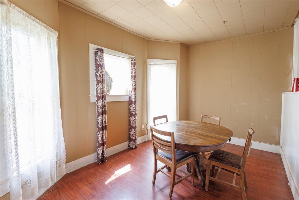2202 Chester Street Sweetwater, TX 79556 - Photo 15 of 21 a view of a dining room with furniture and wooden floor