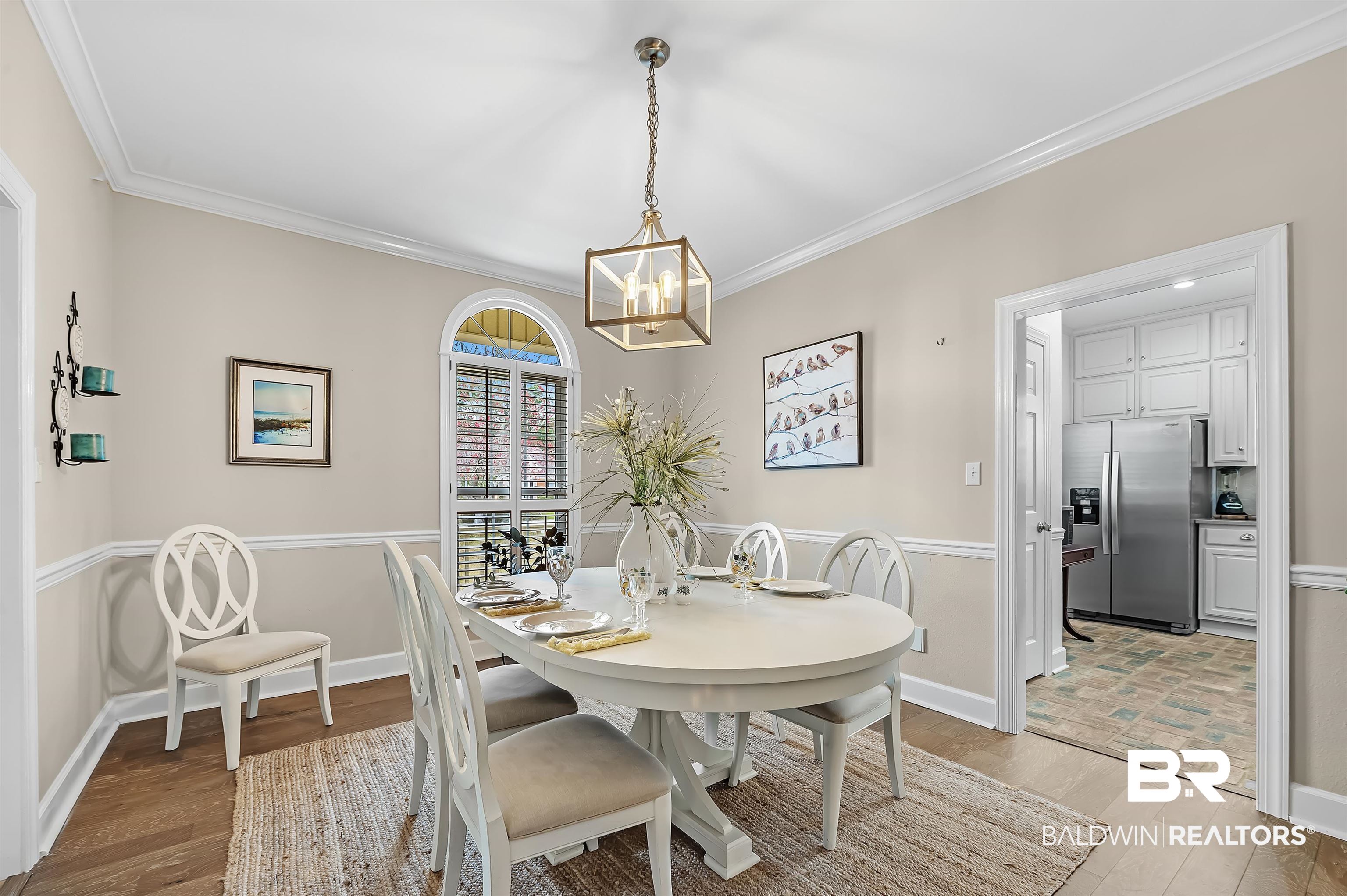 8915 Bay Point Drive Elberta, AL 36530 - Photo 31 of 74 Dining room with light wood-style floors, baseboards, ornamental molding, and a chandelier
