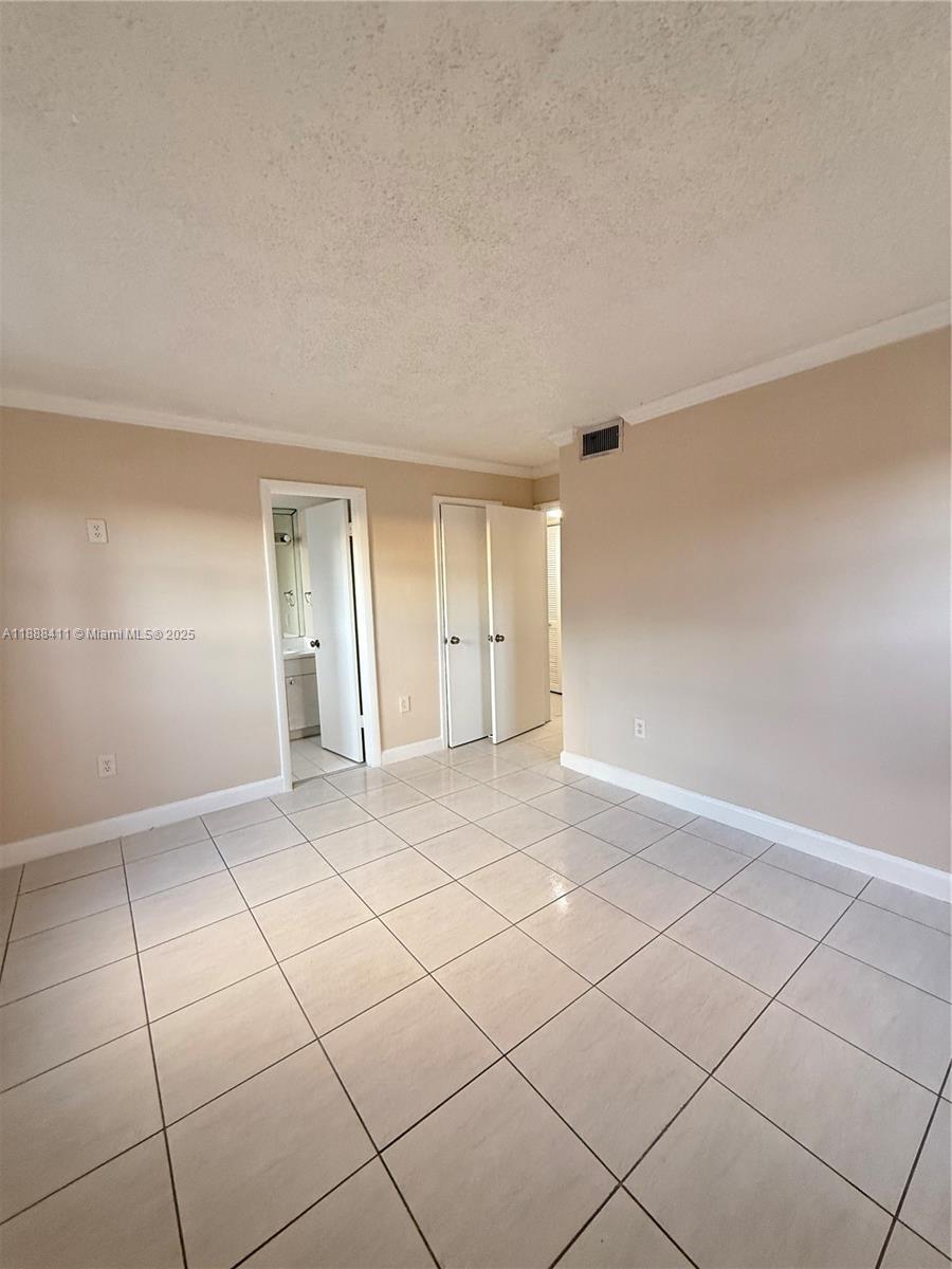 1725 West 60th Street, Unit 105 Hialeah, FL 33012 - Photo 11 of 19 a view of an empty room and window