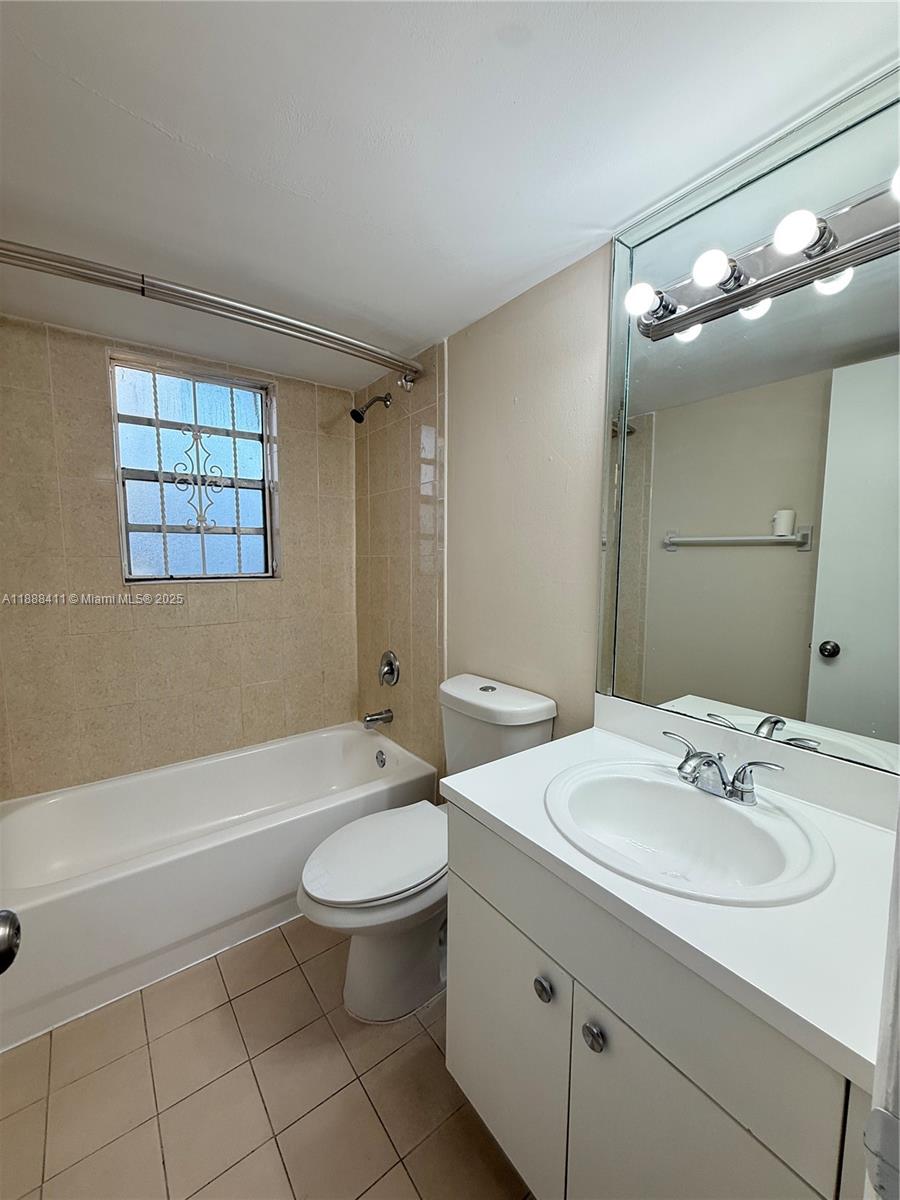 1725 West 60th Street, Unit 105 Hialeah, FL 33012 - Photo 12 of 19 a bathroom with a sink a toilet a mirror and a tub