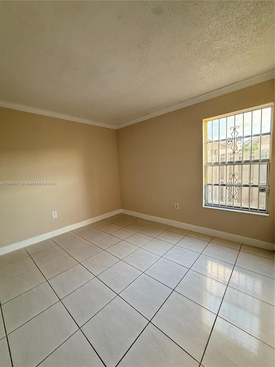 1725 West 60th Street, Unit 105 Hialeah, FL 33012 - Photo 13 of 19 a view of an empty room and a window