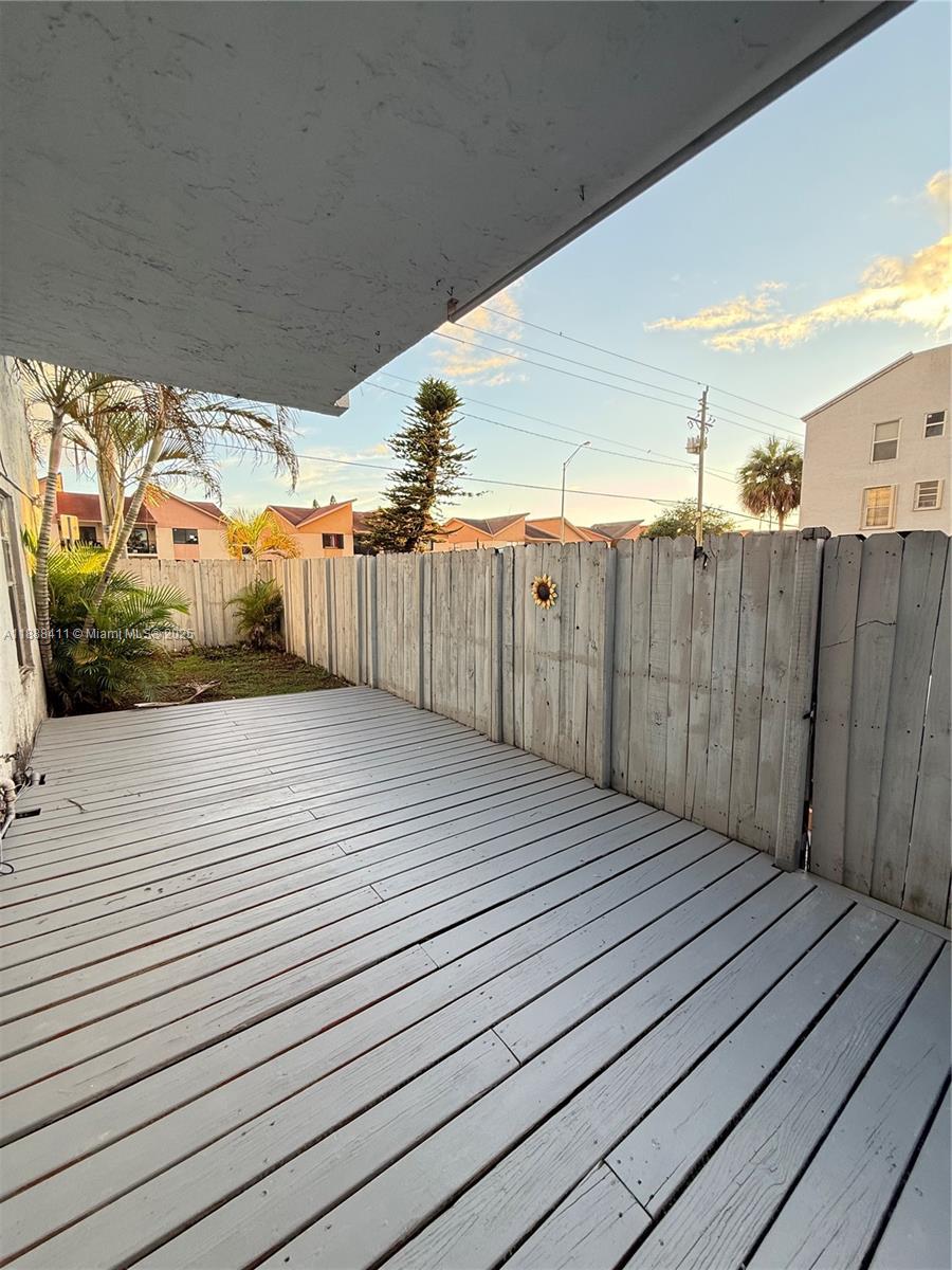 1725 West 60th Street, Unit 105 Hialeah, FL 33012 - Photo 16 of 19 a view of a wooden deck