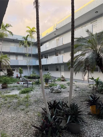a view of a chairs and table in a backyard