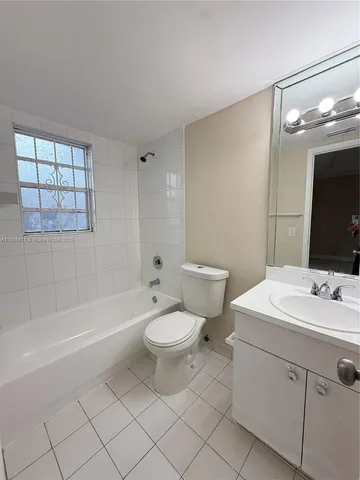 a bathroom with a sink a toilet a mirror and a tub