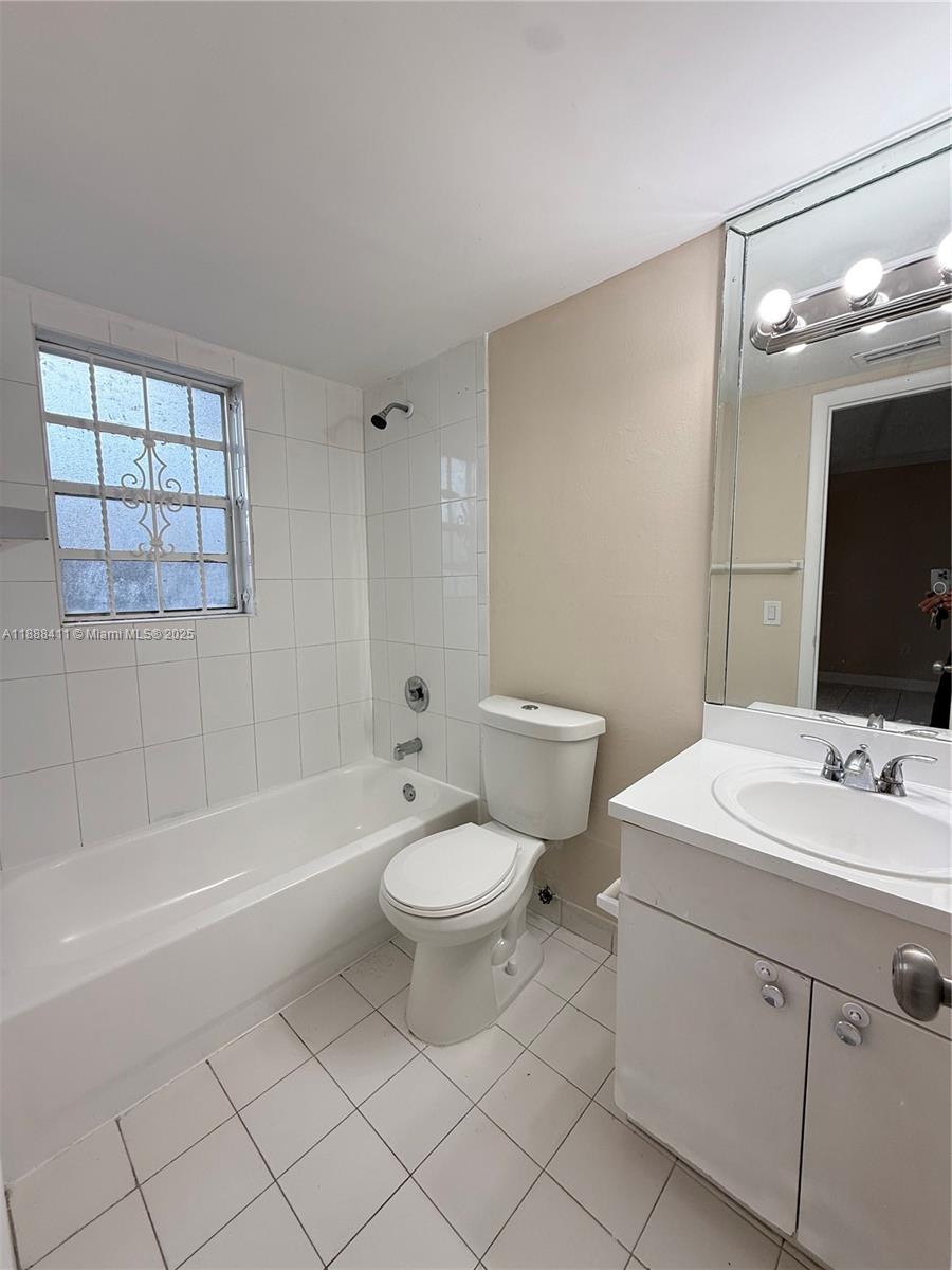 1725 West 60th Street, Unit 105 Hialeah, FL 33012 - Photo 10 of 19 a bathroom with a sink a toilet and shower