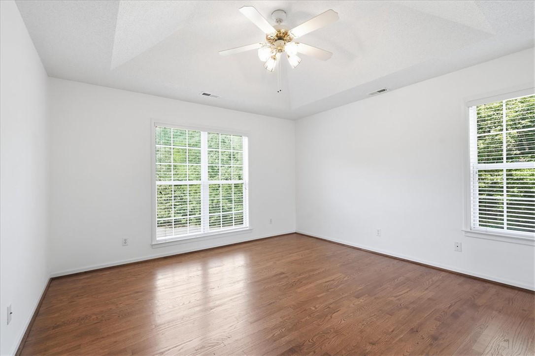 1052 Madden Bridge Road Central, SC 29630 - Photo 7 of 50 Rich wood floors lay a beautiful foundation beneath a classic tray ceiling and multi-pane windows.