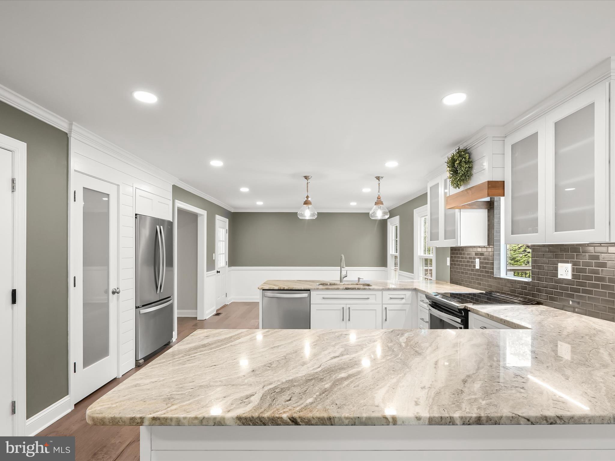 3720 Buffalo Road New Windsor, MD 21776 - Photo 20 of 115 a large white kitchen with kitchen island a large counter top and stainless steel appliances